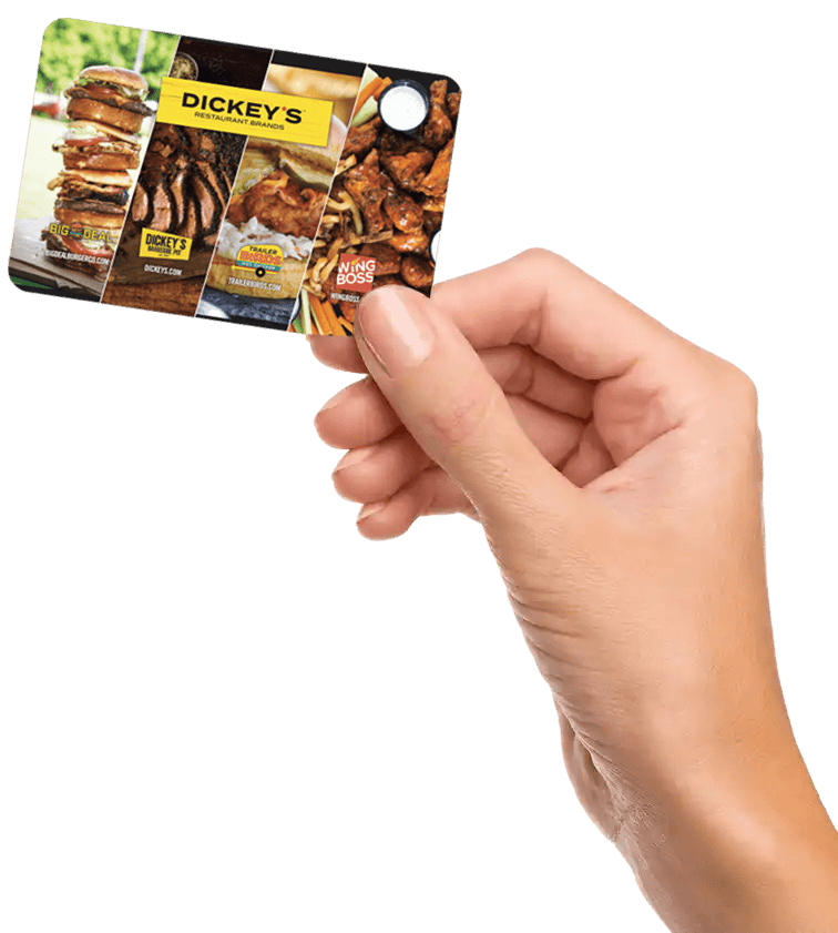 Hand holding Dickey's gift card.