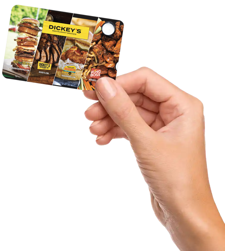 Hand holding Dickey's gift card.